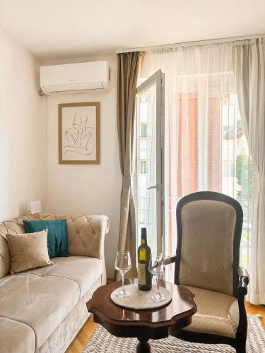 a living room with a couch and a table and a chair at Apartment Melina in Plužine