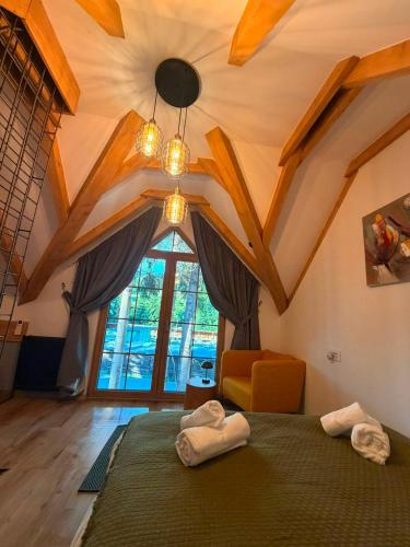 a bedroom with a bed and a large window at Tiny Jazz in Gărâna