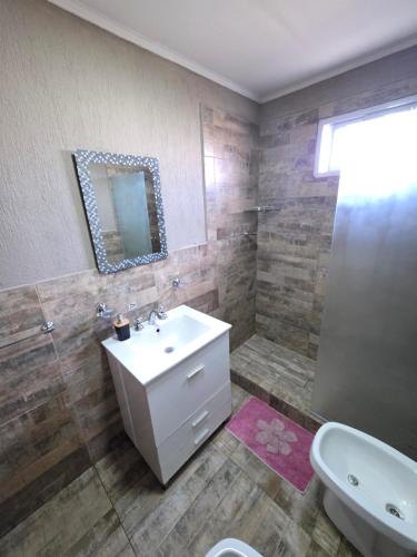 a bathroom with a sink and a toilet and a mirror at arrayanes in Junín