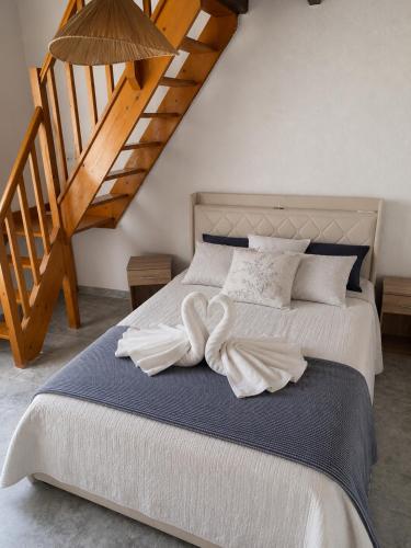 a bedroom with a bed with two white towels on it at Villa Oasis Bollène in Bollène