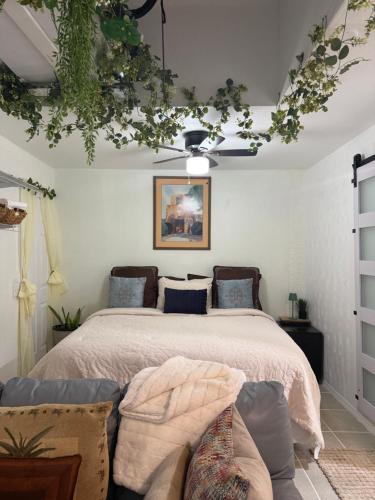 a bedroom with a bed and a couch at Serenity Garden Studio with Pool in Naples