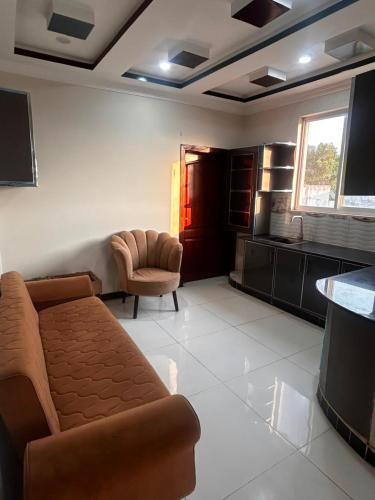 a living room with a couch and a chair at Regal Heights in Bhurban