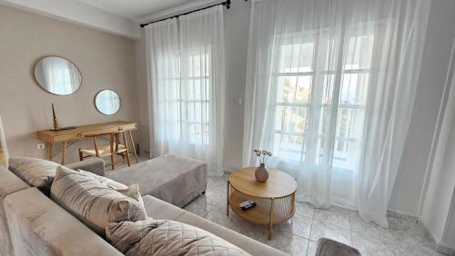 a living room with a couch and a table at Carte Postale Trikeri in Trikeri