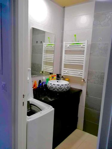 a small bathroom with a sink and a mirror at Hergla Diamond Kais in Sousse
