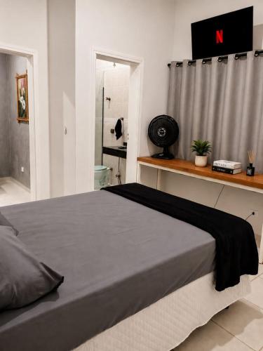 a bedroom with a large bed in a room at Cantinho Da Go in Caraguatatuba
