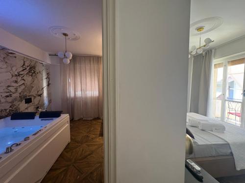 a bathroom with a tub and a large window at BEDBLUESKY-Sparklingsuite nel centro di Dolceacqua in Dolceacqua