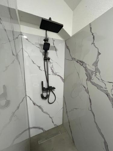 a room with a shower with marble walls at Villa Noor Visoko in Visoko