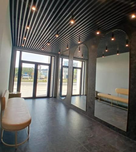 a room with a table and a bench and windows at Adagio Studio Bar in Bar