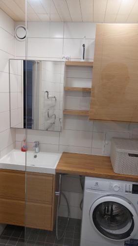a kitchen with a washing machine and a sink at Mugav mereäärne korter in Orissaare