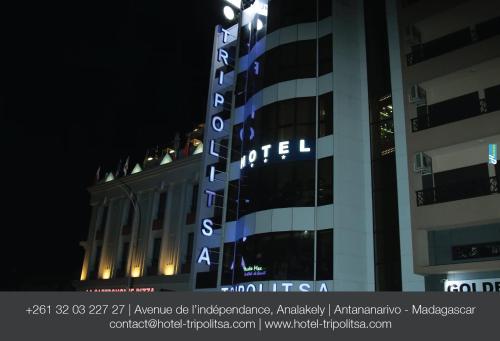 a building with a sign on the side of it at Tripolitsa in Antananarivo