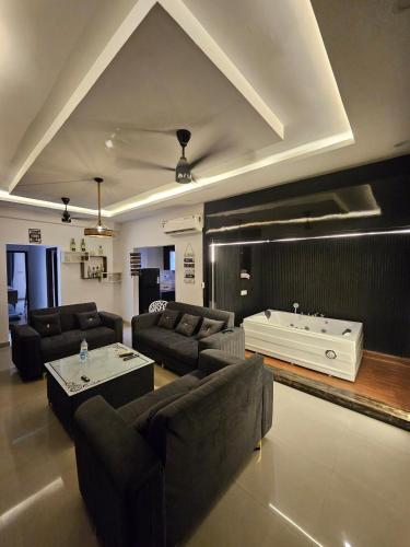 a living room with a couch and a tub at The High View in Mohali