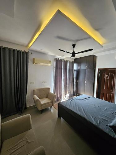 a bedroom with a bed and a chair at The High View in Mohali