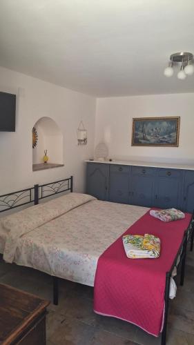 a bedroom with a bed and a red table at Villa daniela in Taormina