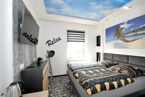 a bedroom with a bed and a desk and a window at Sleep Inn Hotel in Paderborn