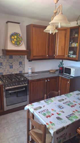 a kitchen with a table and a stove top oven at Villa daniela in Taormina