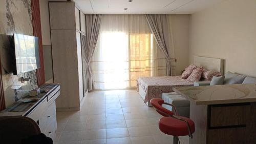 a hotel room with a bedroom with a bed and a window at 731 الكارما in El Gouna