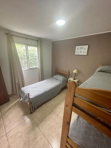 a bedroom with two beds and a window at Casa quinta Camino al Sol in Junín