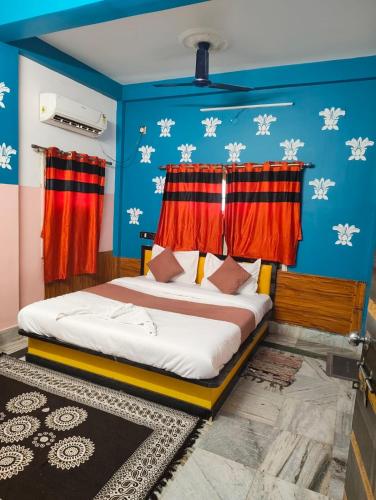 a bedroom with a bed with red curtains at Hotel Lotus in kolkata