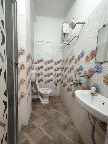 a bathroom with a toilet and a sink at Hotel Lotus in kolkata