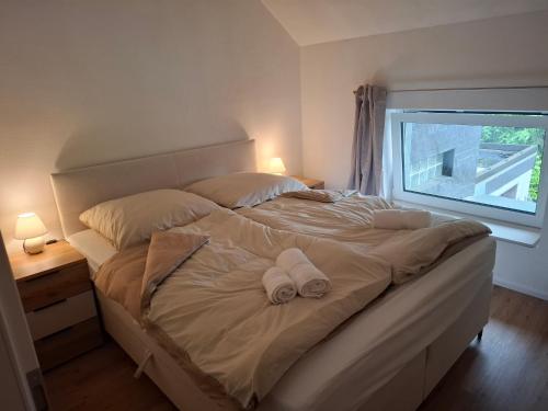 a bedroom with a bed with two towels on it at EifelAuszeit in Simmerath
