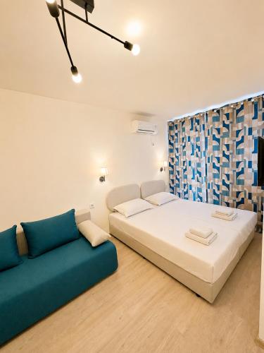 a living room with a bed and a couch at AM Sea Studios in Ravda
