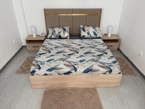 a bedroom with a large bed with blue birds on it at Talia in Bejaïa
