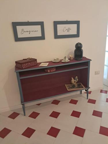 a dresser in a room with two pictures on the wall at Bibi House in Sassari