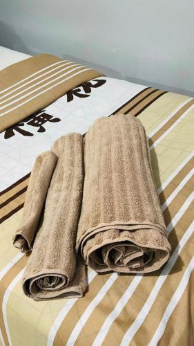 a bed with two towels on top of it at 52Golfcourseview guest house in Pimville