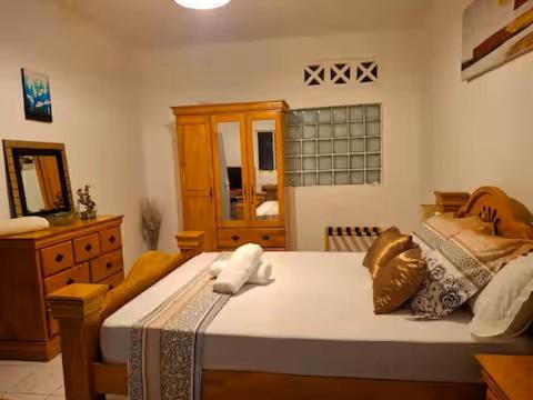 a bedroom with a large bed and a dresser at Case Kiyas in Mamoudzou