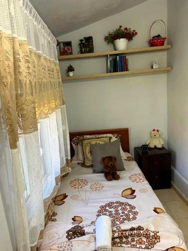 a bedroom with a bed with a teddy bear on it at Koman Rest Point in Koman