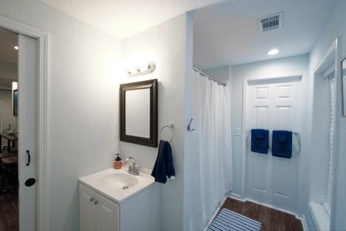 a white bathroom with a sink and a mirror at Dolphin Retreat in Brunswick
