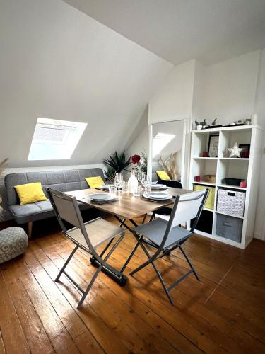 a dining room with a table and two chairs at Le petit nid rouennais in Rouen