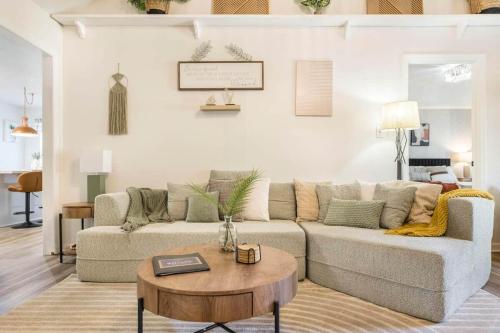 a living room with a couch and a table at Greenway Oasis 3BR home in Hidden Oaks