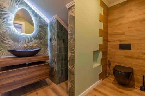 a bathroom with a vessel sink and a mirror at Vivenda Verivitor - Saltwater Pool, Garden, BBQ & Tennis Court in Sesimbra