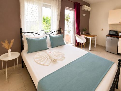 a bedroom with a large bed with blue and white at Rethymno Blue Residence in Rethymno