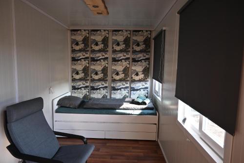 a small room with a bed and a chair at Single room - small cabin - stuga - self check in - Gällivare Koskullskulle in Koskullskulle