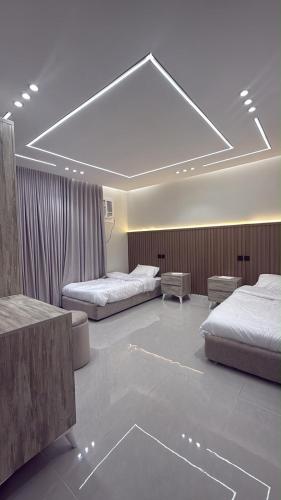 a hotel room with two beds and aception at شقة سحاب ابها in Abha