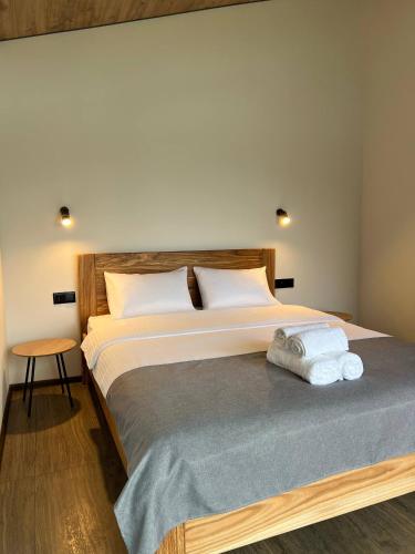a bedroom with a large bed with towels on it at Sviy home in Slavske