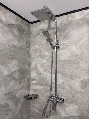 a shower with a shower head in a bathroom at Sviy home in Slavske