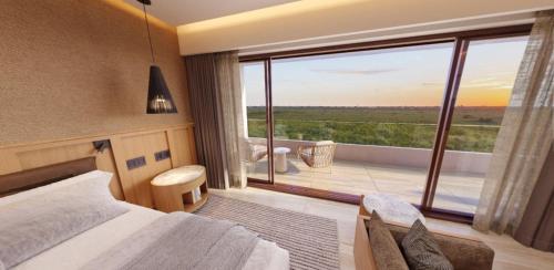 a hotel room with a bed and a large window at Inna Resort & Spa in Puerto Morelos