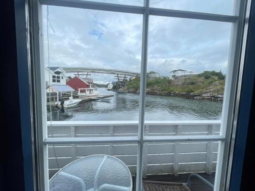 a window with a view of a river and a bridge at Nautnes Costal Heaven in Nautnes