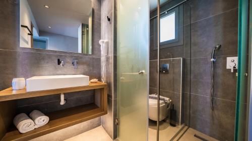 a bathroom with a sink and a shower at Harmony Crest Resort in Kos