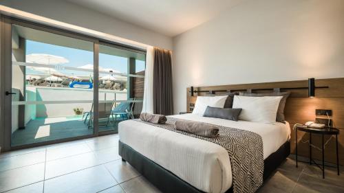 a bedroom with a bed with a view of the ocean at Harmony Crest Resort in Kos