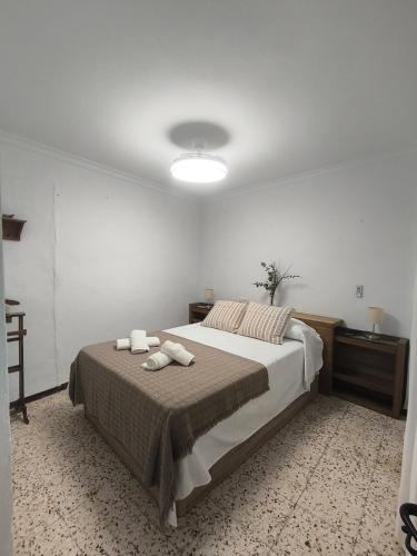 a bedroom with a bed with two towels on it at Casa la parra in Ardales