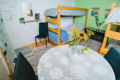 a room with a table and a bunk bed at Värska kämping in Värska
