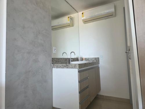 a kitchen with a sink and a counter top at Lindo Duplex na orla de Pajuçara in Maceió