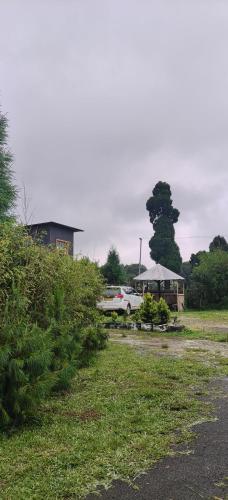 a car parked in a yard next to a house at Rimaaia homestay in Lāitlyngkot
