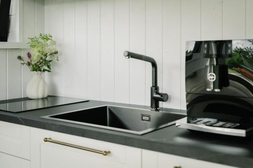 a kitchen counter with a sink and a coffee maker at Majakavahi in Sääre