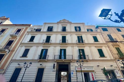 a large white building with windows on a street at Villa Lucia in Torre del Greco