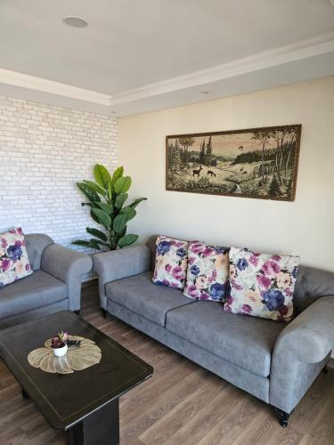 a living room with a couch and a table at Rakkez's house in Hiboun